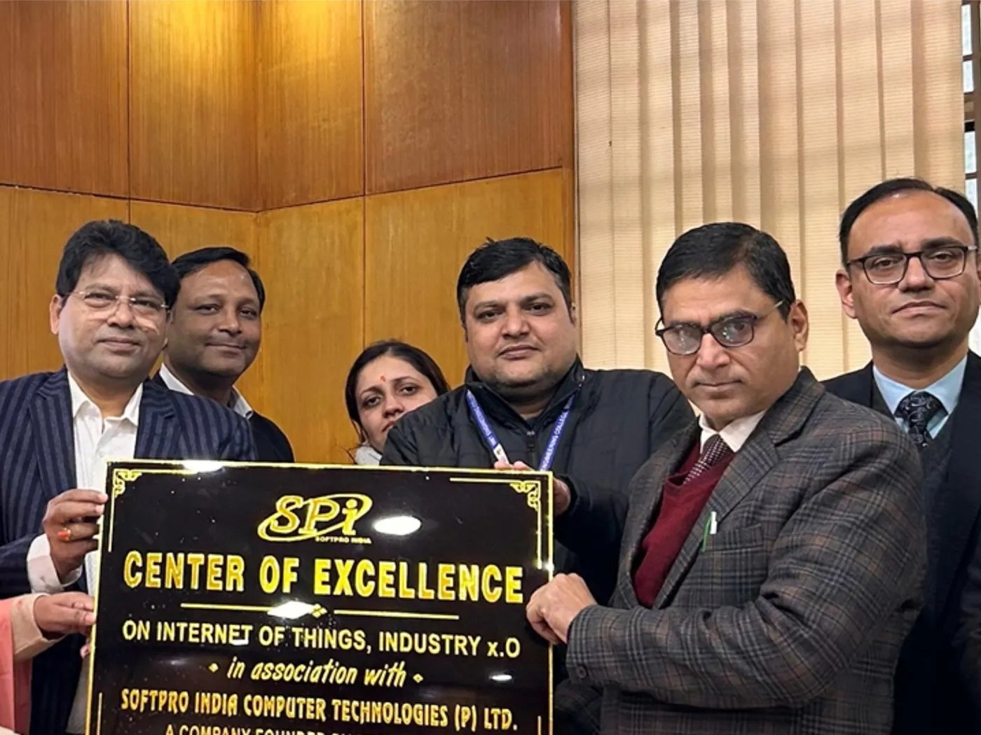 SSS India and IIMT University staff holding the Center of Excellence name plate