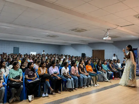 Wide view of a full auditorium during a SSS session, students seated shoulder to shoulder